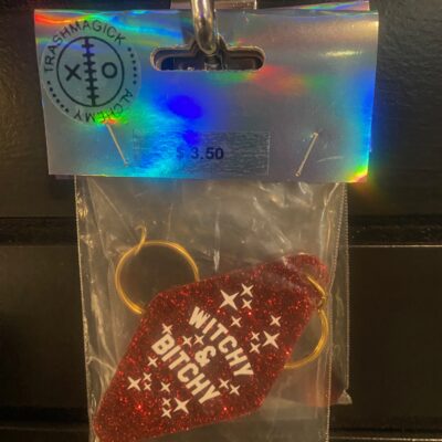 ✨ Witchy & Bitchy Keychain — Your Energy, In Keychain Form ✨ For the babe who casts spells and side-eyes — this glittery little talisman says what you’re too tired to repeat. Clip it to your keys, bag, broom, or emotional boundaries and let the world know: you’re enchanting, you’re edgy, and you do not have time for nonsense. Red, glittery, and unapologetically loud — just like your aura on a good day.