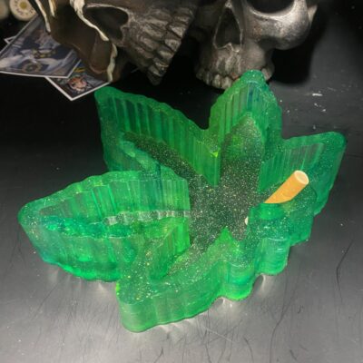 Custom resin weed leaf ashtray with glitter. A bold, handmade piece perfect for smokers, stoners, and herb-loving gift givers.