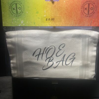 👠 “HOE BAG” Zippered Pouch Is it a label? A lifestyle? A warning? Yes. This bold little baddie says exactly what it is—and that’s why we love her. Whether you’re packing lashes and lube, crystals and condoms, or just a chaotic sense of self-worth, this bag carries your essentials with zero shame and maximum slay. Printed in a sexy black script font on durable white canvas with a secure zip, the Hoe Bag is your not-so-subtle sidekick for nights out, walk-of-shames, or just looking hot and unbothered.