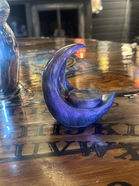 Handmade resin moon candle holders by Trashmagick Alchemy. Custom altar décor with unique colors, glitter, shimmer, and cosmic designs.